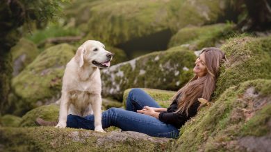 woman with dog on rocks