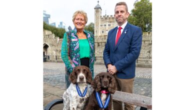 PDSA Director General, Jan McLoughlin, and Stuart Phillips (handler), with Yoyo (right) and Scamp (left)