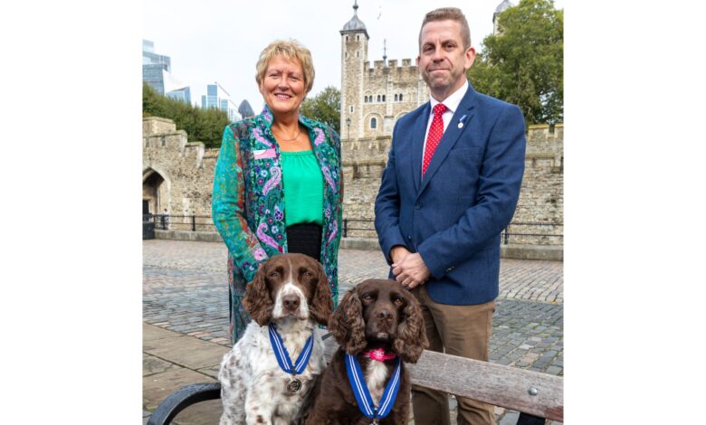 PDSA Director General, Jan McLoughlin, and Stuart Phillips (handler), with Yoyo (right) and Scamp (left)